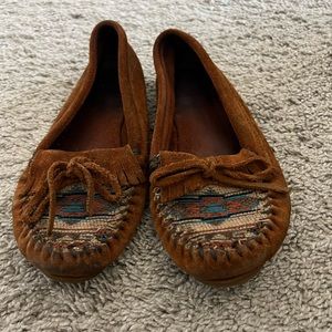 Minnetonka moccasins with tribal detail on front